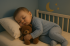 create a realistic horizontal image for an article about baby sleep regression, showing a baby in different sleep positions and a calm, soothing background
